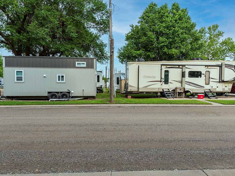 Fifth-wheel on paved site next door to park model at K & R RV PARK