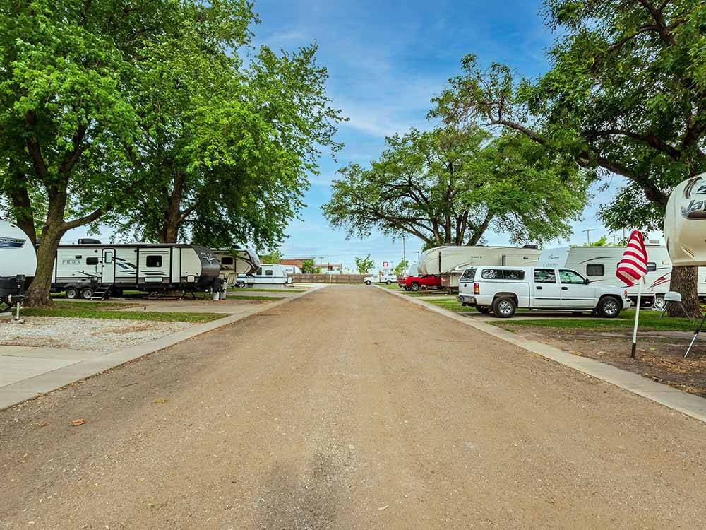 Straight road flanked by paved RV sites at K & R RV PARK