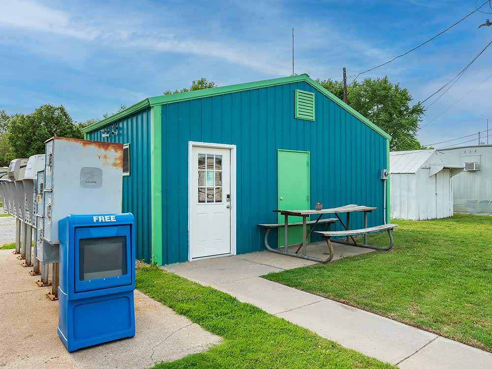 Blue building with mail boxes along the side at K & R RV PARK