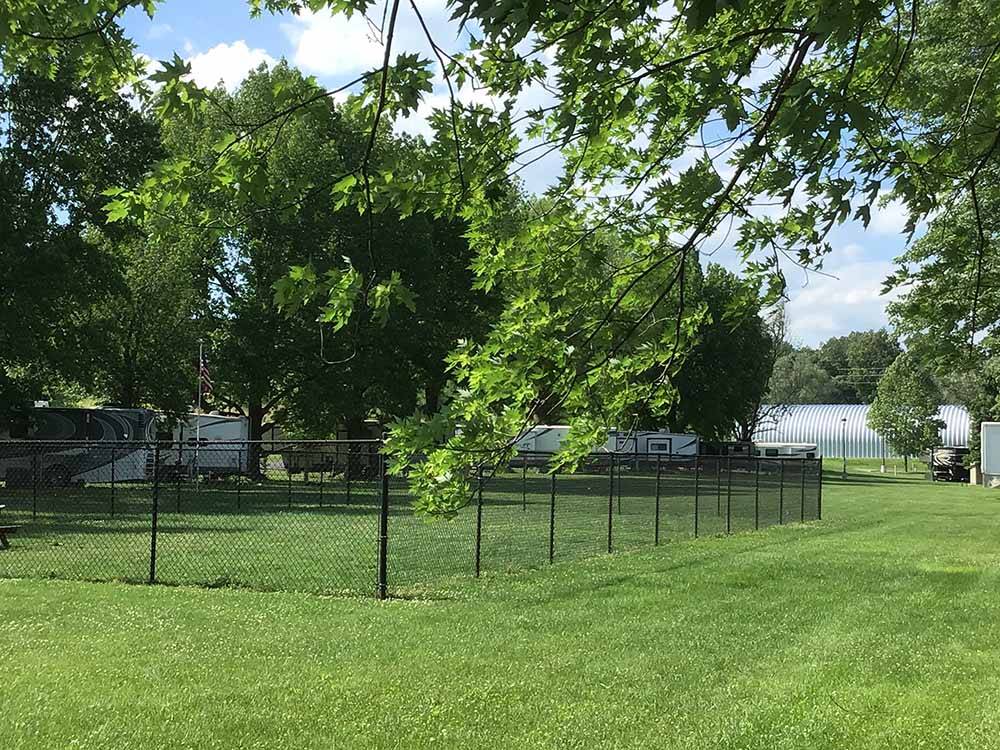 A fenced in grassy area at THE LANDING POINT RV PARK