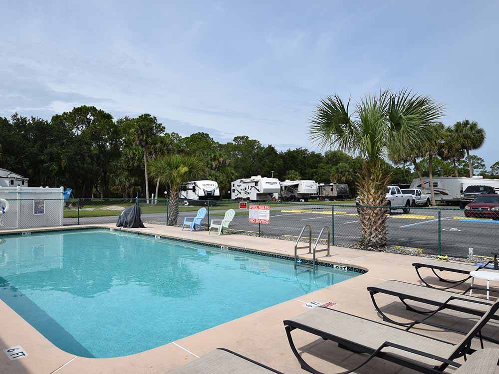 Swimming pool with lounge chairs at JOY RV RESORT