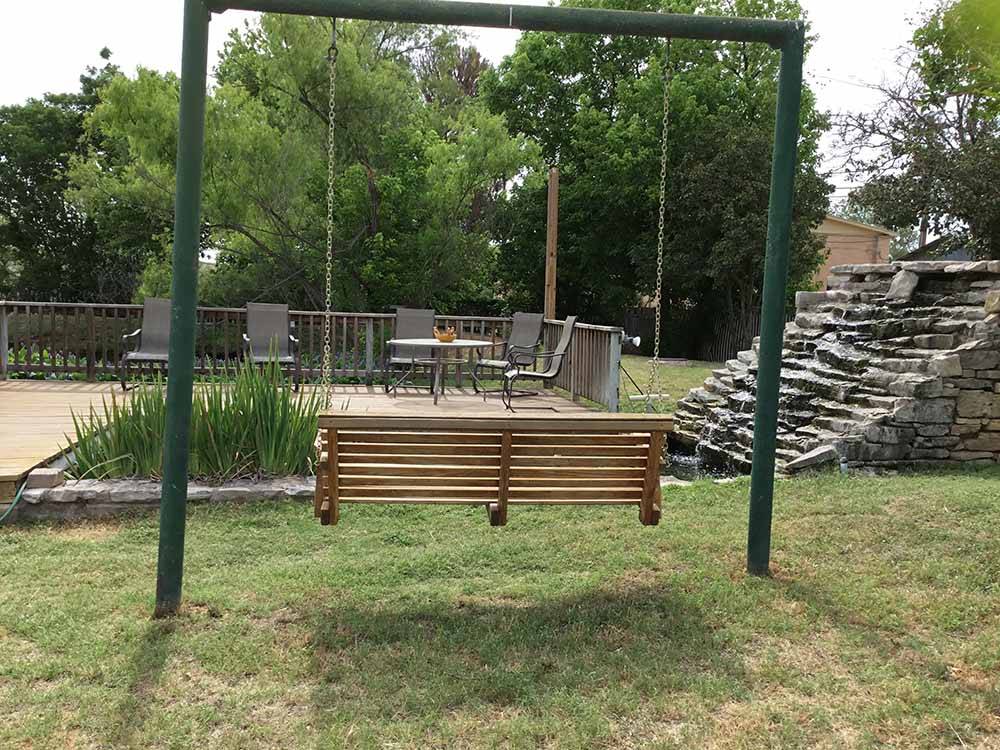 A bench swing looking at a seating area at FREDERICKSBURG RV PARK