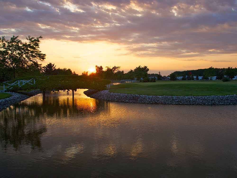 Water around a putting green at WILDWOOD GOLF & RV RESORT