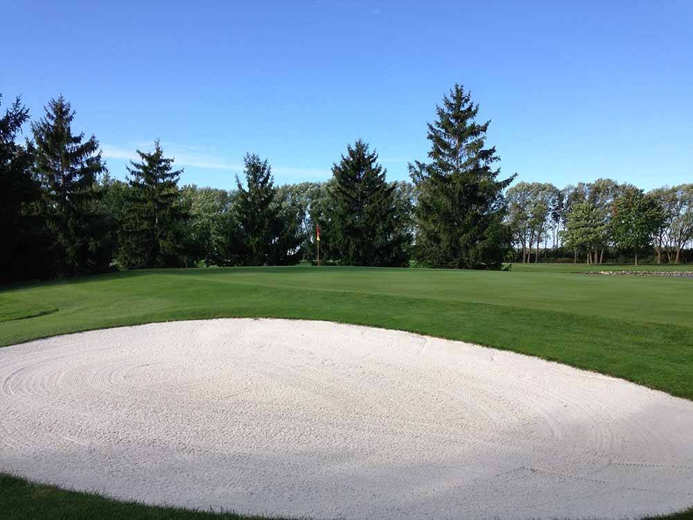 A well groomed sand trap at WILDWOOD GOLF & RV RESORT