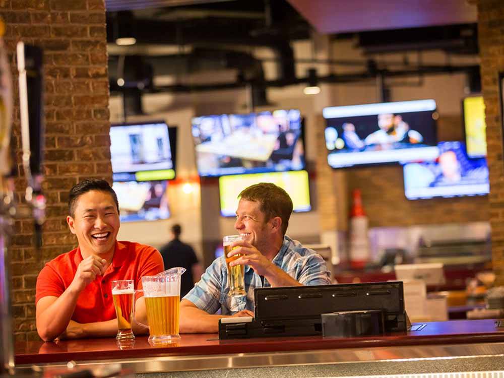 A couple of guys drinking beer in the sports bar at LITTLE RIVER CASINO RESORT RV PARK