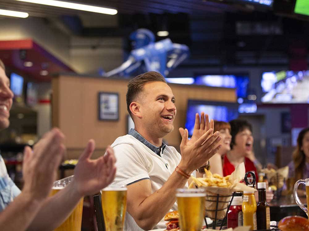 People clapping at the sports bar at LITTLE RIVER CASINO RESORT RV PARK