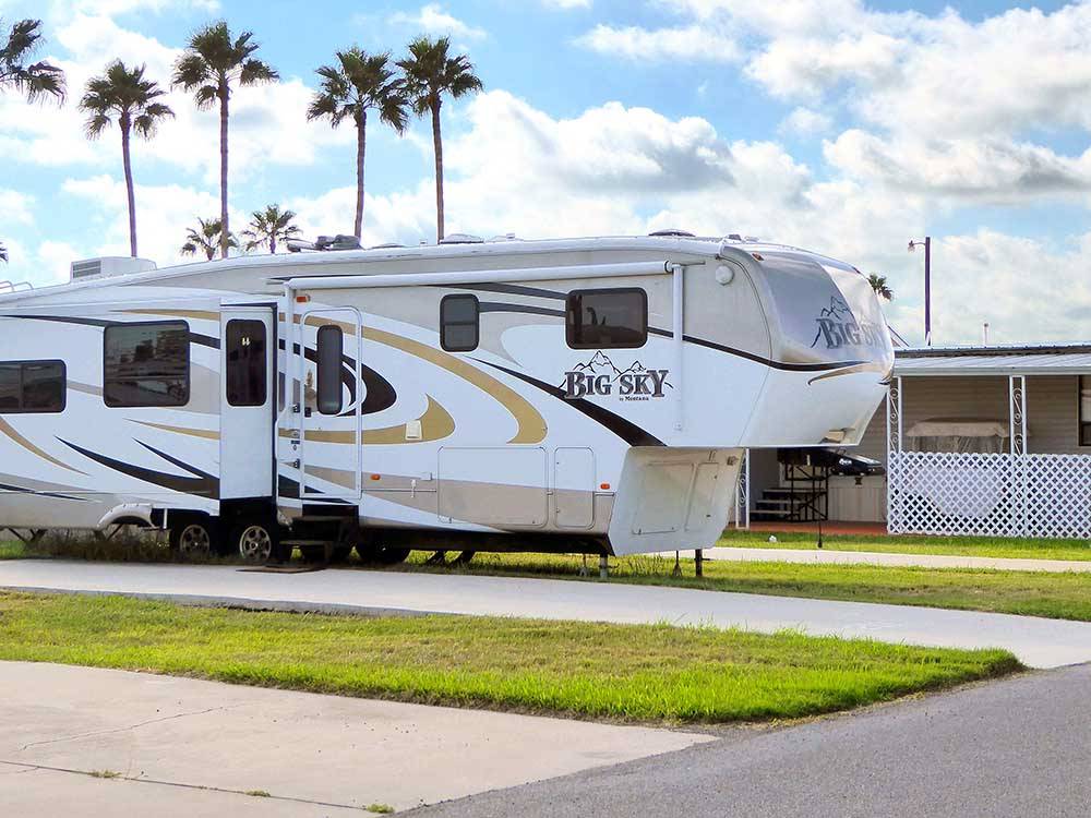 A fifth wheel parked on-site at SNOW TO SUN RV RESORT