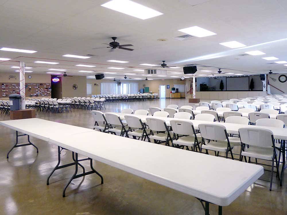 Long tables inside a large conference room at SNOW TO SUN RV RESORT