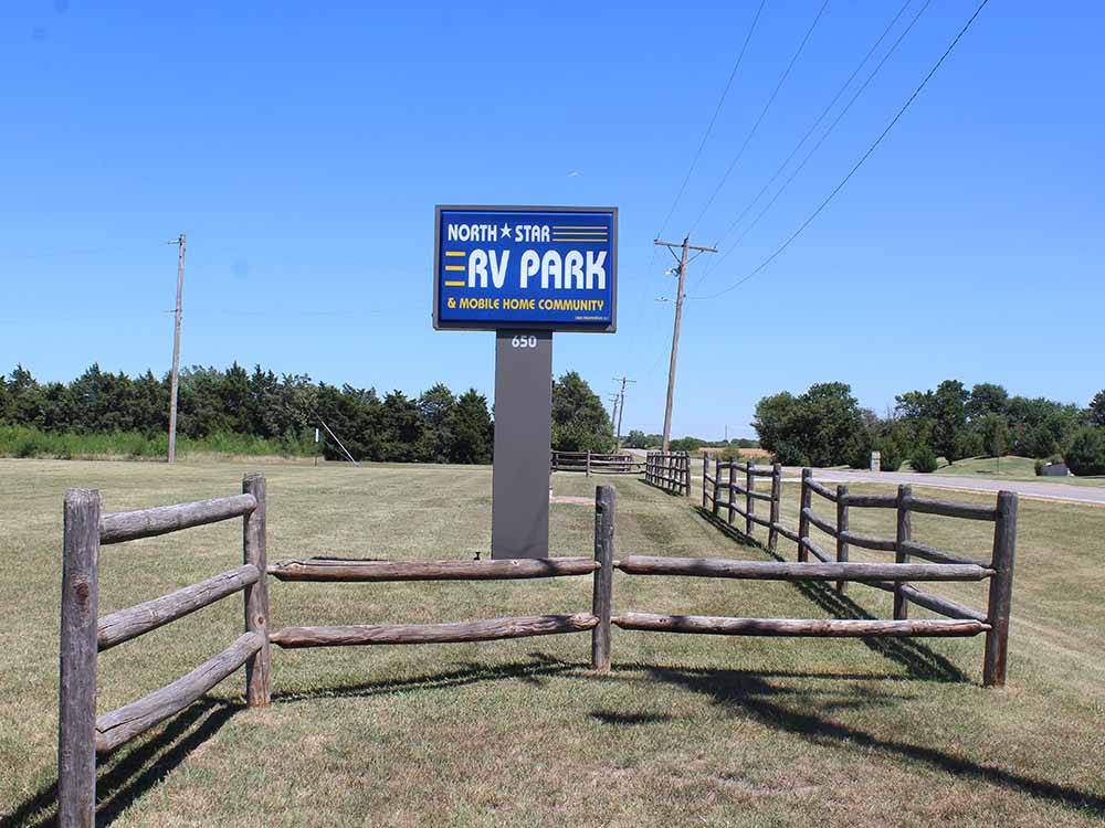 Sign for campground next to a fence at NORTH STAR RV PARK