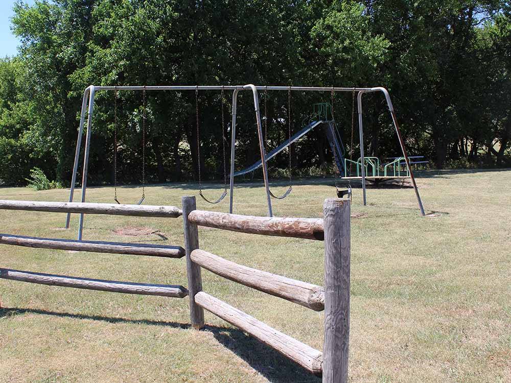 Swingset, slide and merry go round at NORTH STAR RV PARK