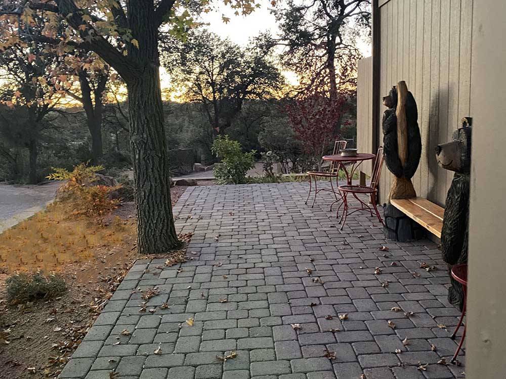 A stone paver patio with a bench at PAYSON CAMPGROUND AND RV RESORT