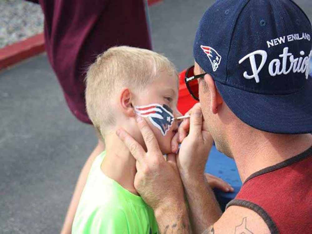 Child having his face painted at STATELINE CAMPRESORT & CABINS