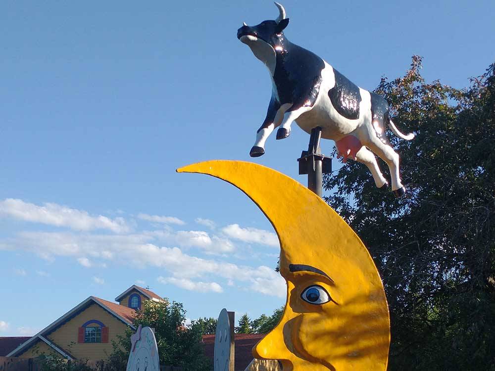 A whimsical sculpture of a cow and moon  at WYLIE PARK CAMPGROUND & STORYBOOK LAND