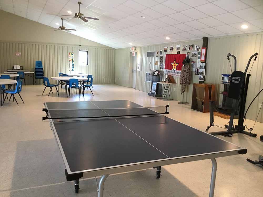 The ping pong table with round tables in the background at CARTHAGE RV CAMPGROUND