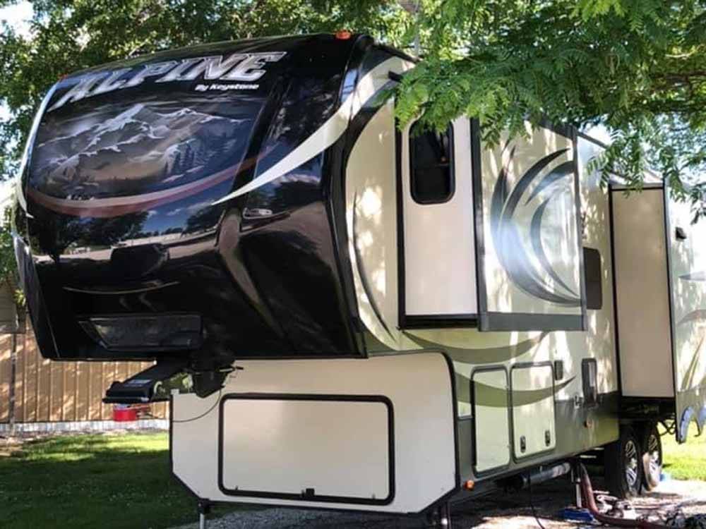 Fifth wheel in campsite at NEW VISION RV PARK