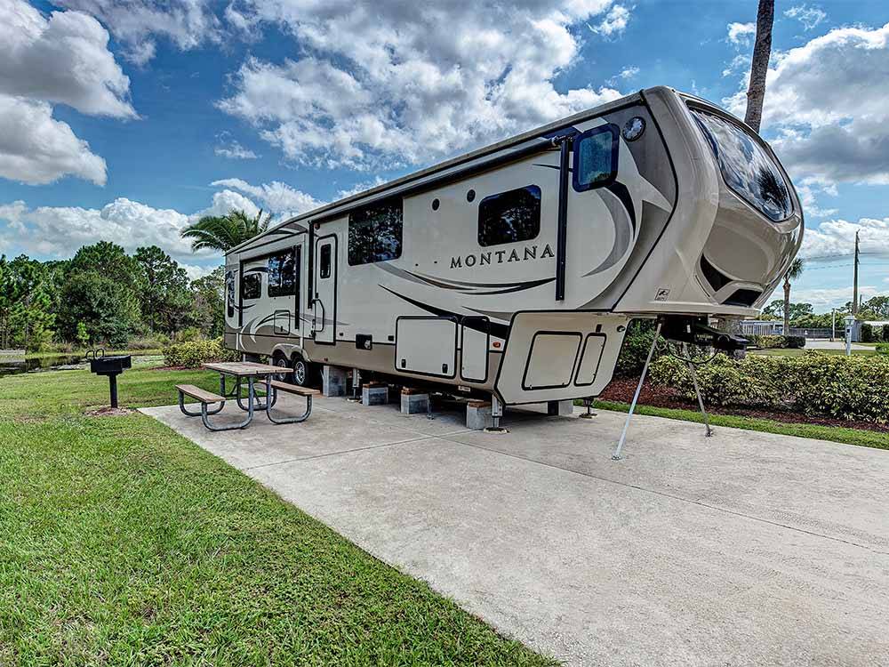 A fifth wheel trailer in a paved back in RV site at OUTBACK RV RESORT AT TANGLEWOOD