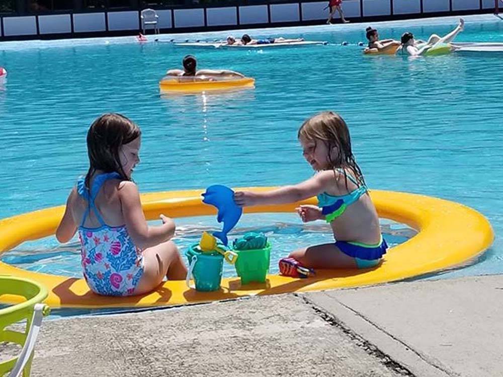 A couple of girls playing in the swimming pool at MOUNTAIN PINES CAMPGROUND