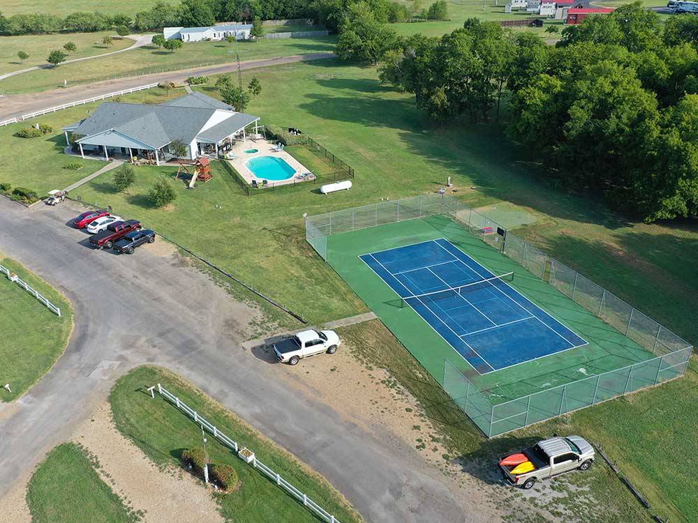 Aerial view of pool and tennis/pickleball court at BLUEBONNET RIDGE RV PARK & COTTAGES