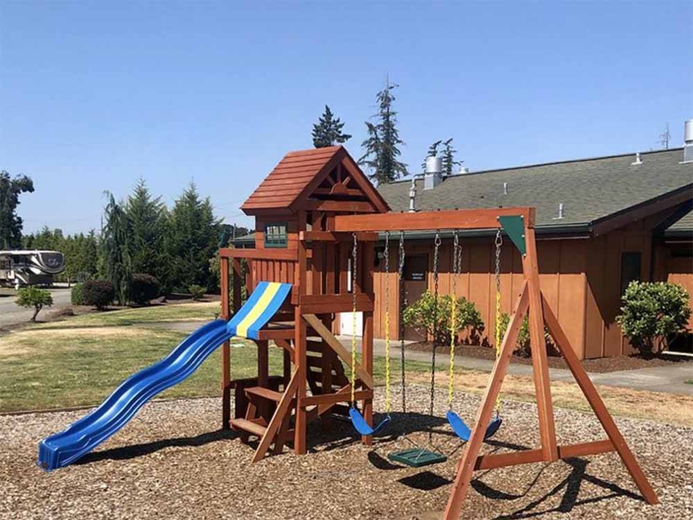 The wooden playground equipment at SILVER SPUR RV PARK & RESORT