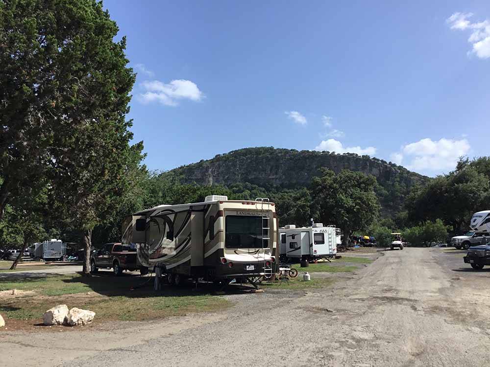 A row of RV sites with trees at PARKVIEW RIVERSIDE RV PARK