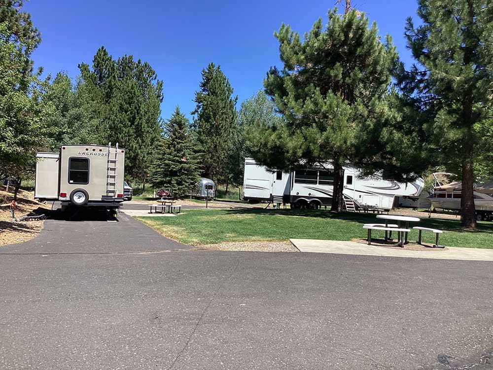 A paved pull thru RV site with picnic table at MCCALL RV RESORT