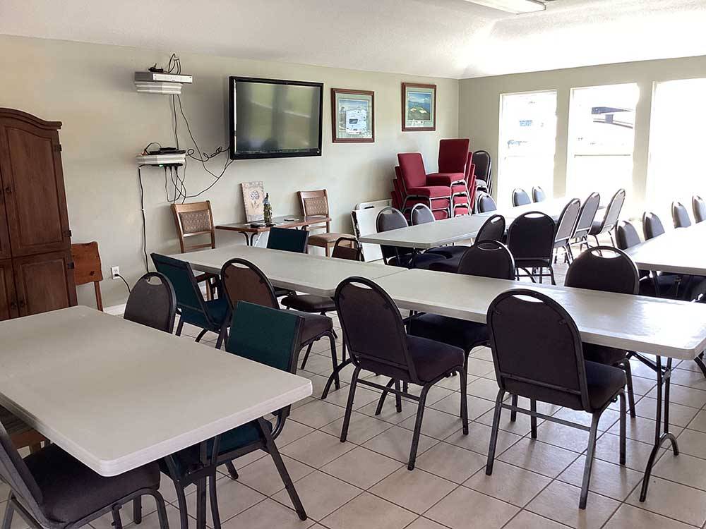 Tables and chairs in the rec room at RV HIDEAWAY CAMPGROUND