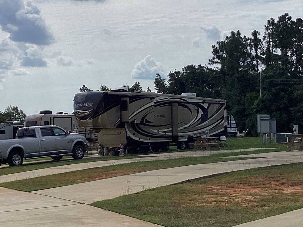 A fifth wheel trailer backed in at RV HIDEAWAY CAMPGROUND