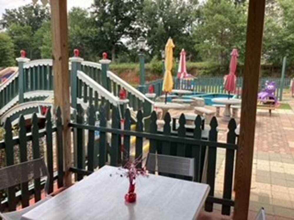 A sitting area next to the playground at WALES WEST RV RESORT & LIGHT RAILWAY