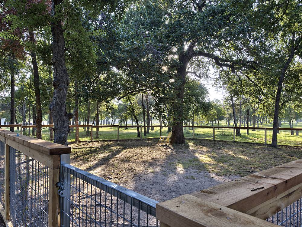 The fenced in pet area at OAK FOREST RV RESORT