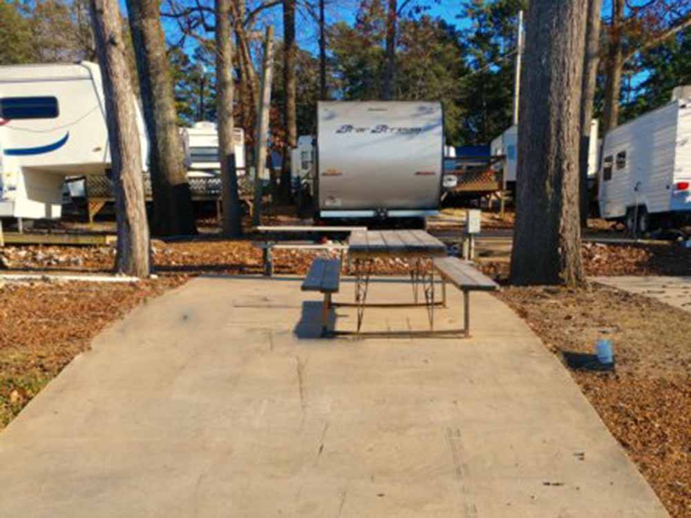 A picnic bench at a paved RV site at BIRDSONG RESORT & MARINA LAKESIDE RV & TENT CAMPGROUND
