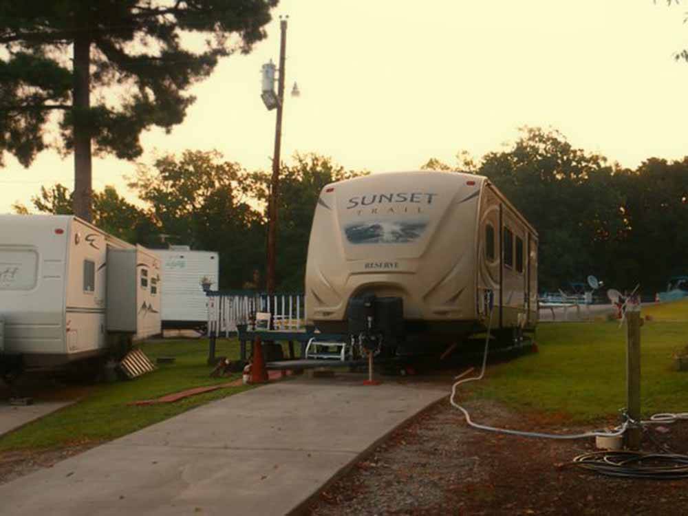 A travel trailer in a back in RV site at BIRDSONG RESORT & MARINA LAKESIDE RV & TENT CAMPGROUND