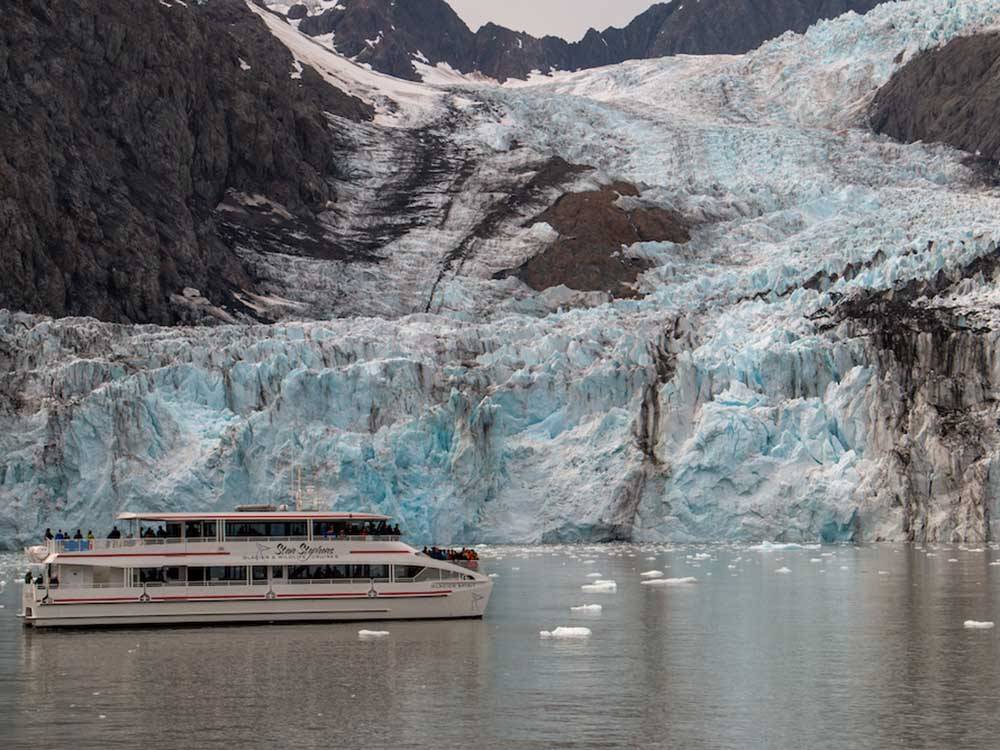 View of tour boat next to glacier at STAN STEPHENS GLACIER & WILDLIFE CRUISES