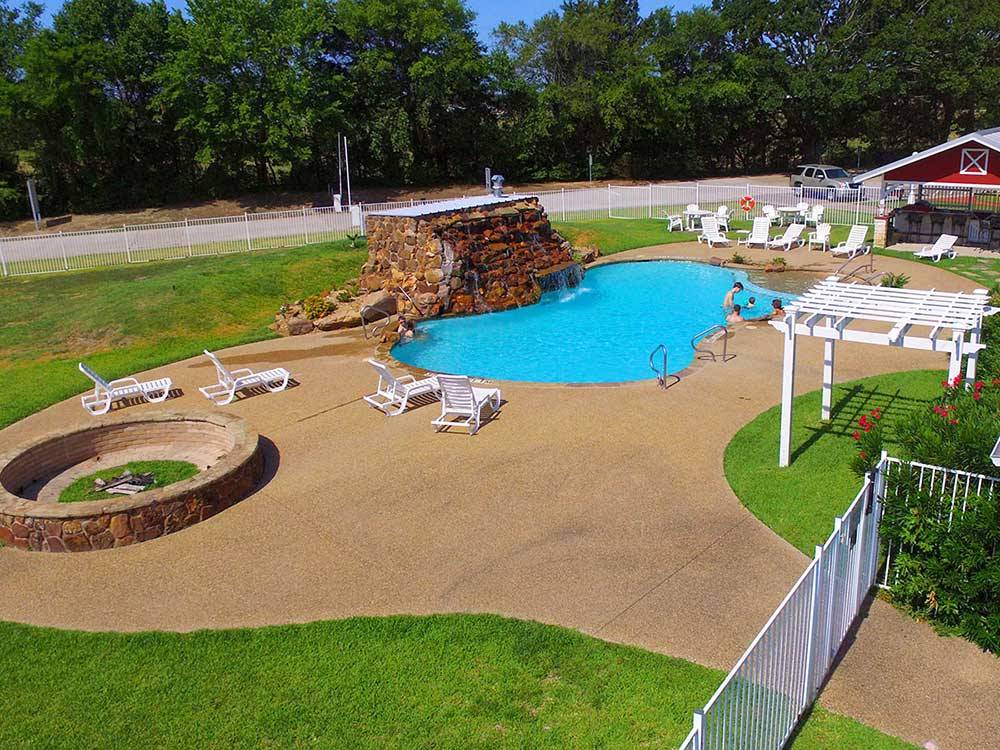 Swimming pool and nearby fire pit at MILL CREEK RANCH RESORT