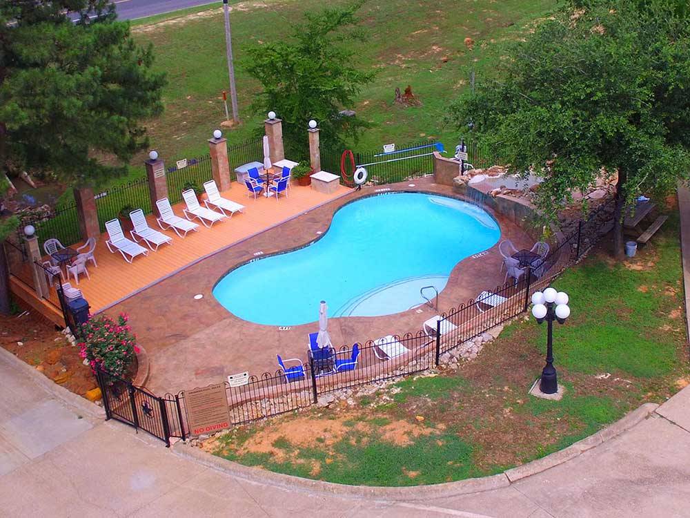 Swimming pool with outdoor seating at SHALLOW CREEK RV RESORT