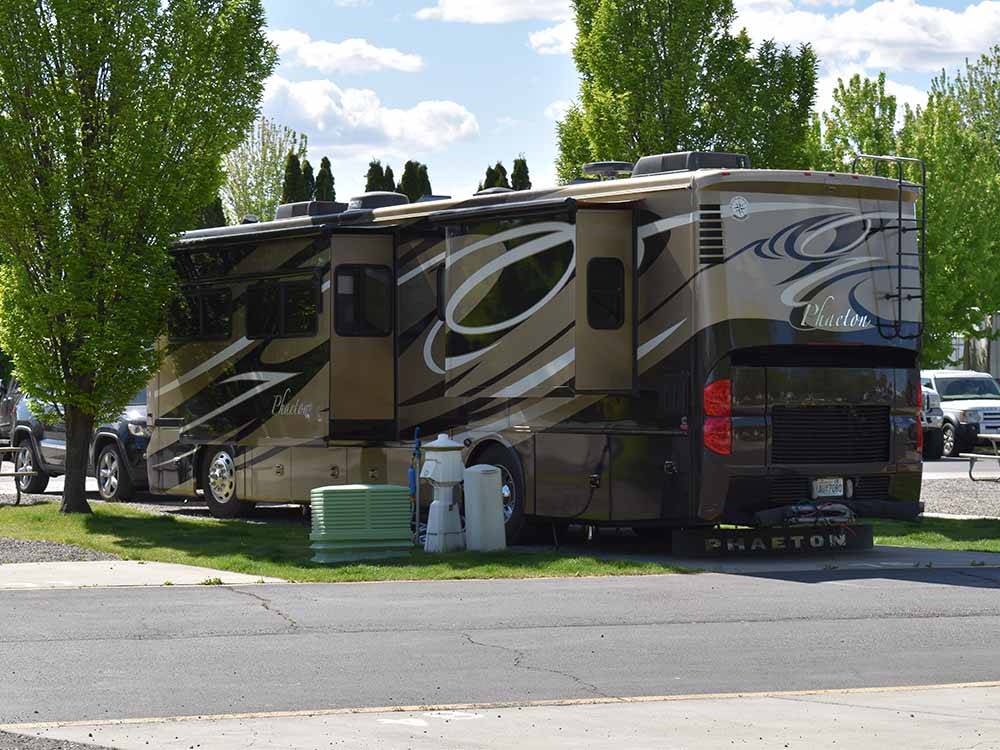 A motorhome in a paved RV site at HORN RAPIDS RV RESORT