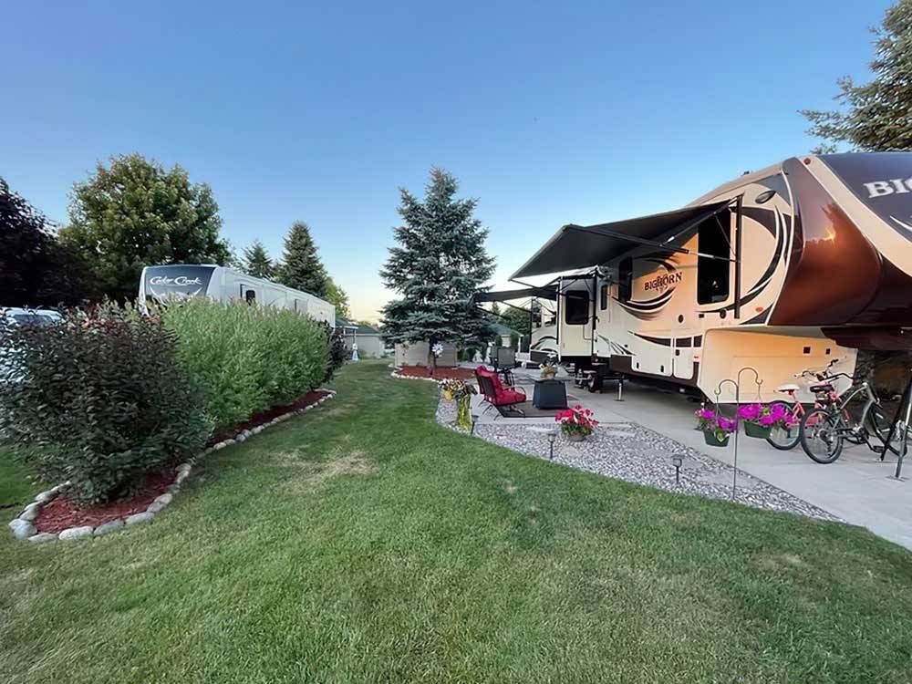 Fifth-wheel with big patio and green belt at TRAVERSE BAY RV RESORT