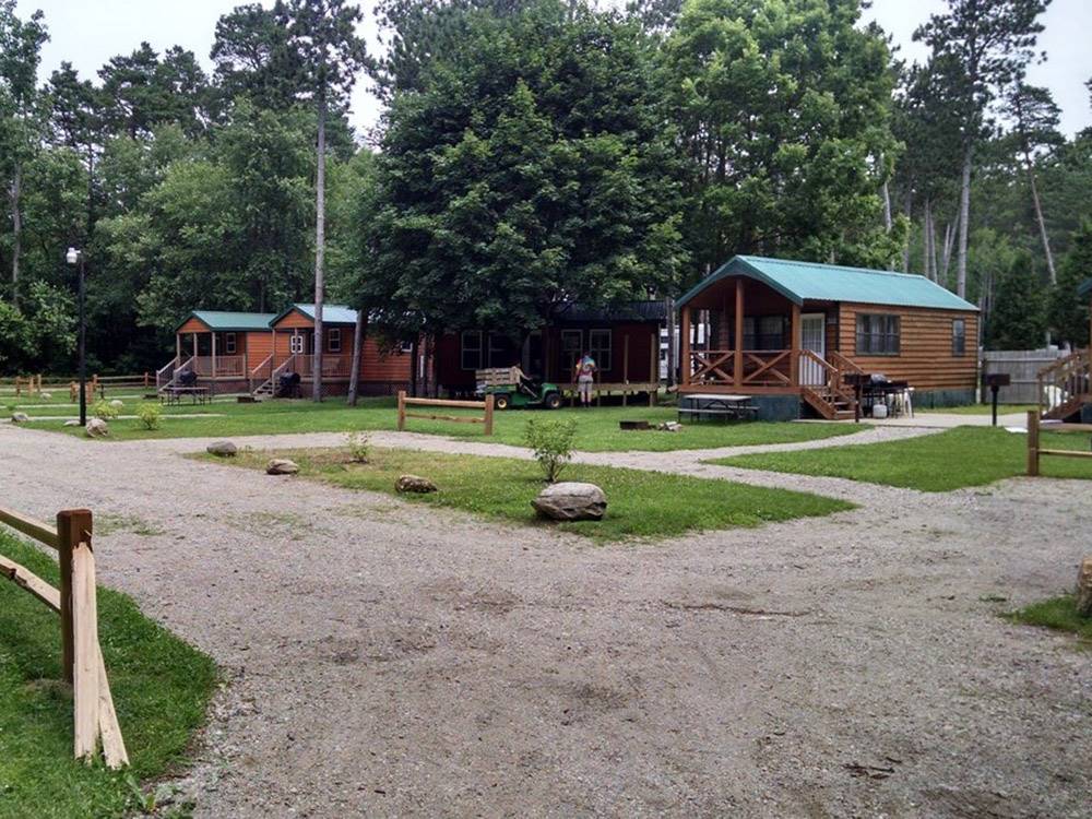 The wooden rental cabins at MUNCIE RV RESORT BY RJOURNEY