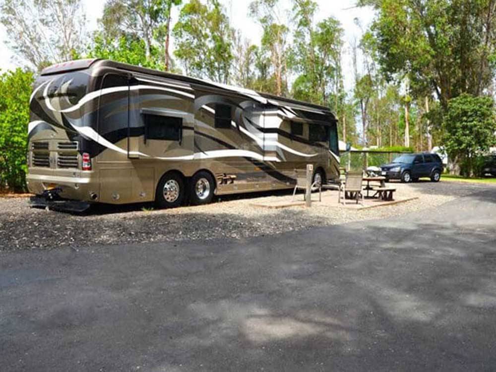 A motorhome in a gravel RV site at MIDWAY RV PARK