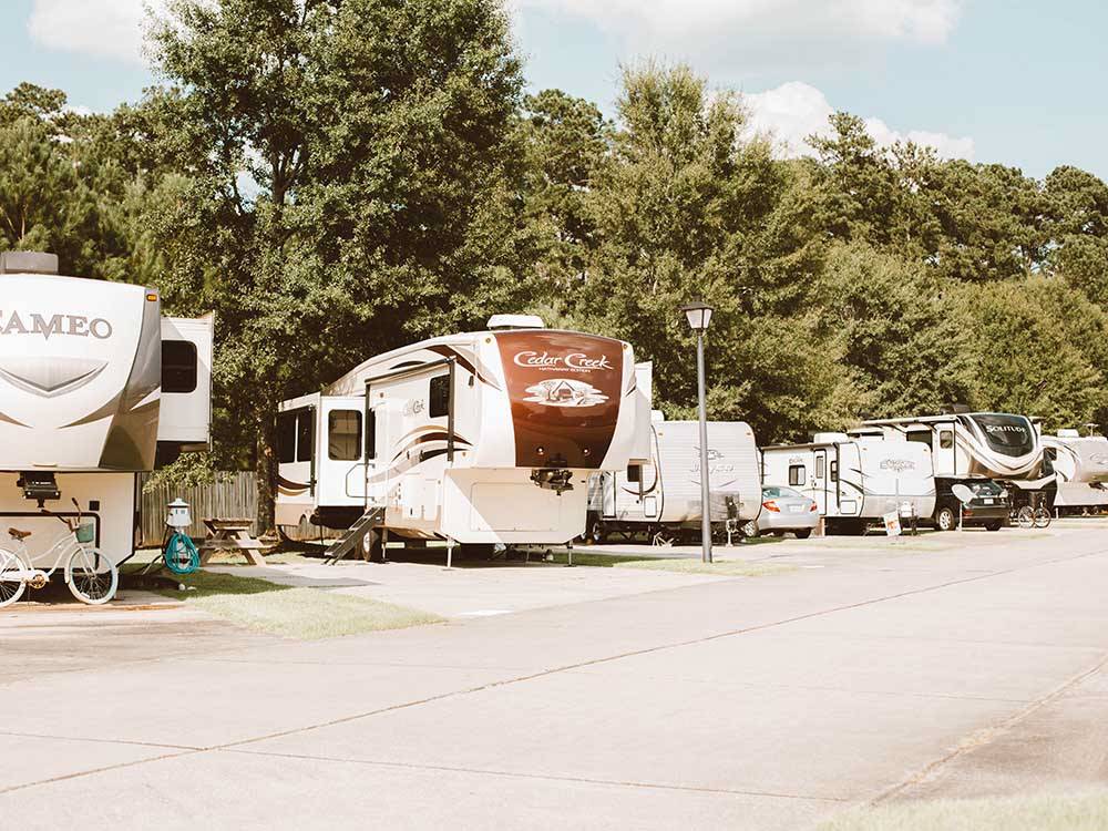 A long row of occupied RV sites at LAKESIDE RV RESORT BY RJOURNEY