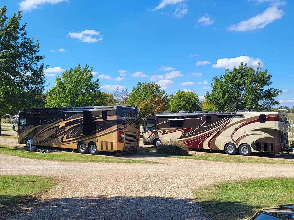 Two motorhomes parked in gravel sites at CANTON I-20 RV PARK