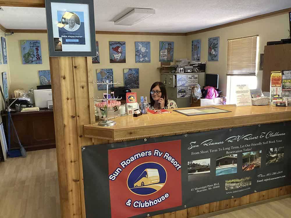 A receptionist at the front desk at SUN ROAMERS RV RESORT