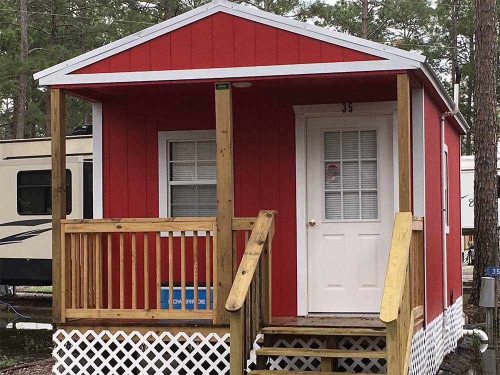 The red rental cabin at SUN ROAMERS RV RESORT