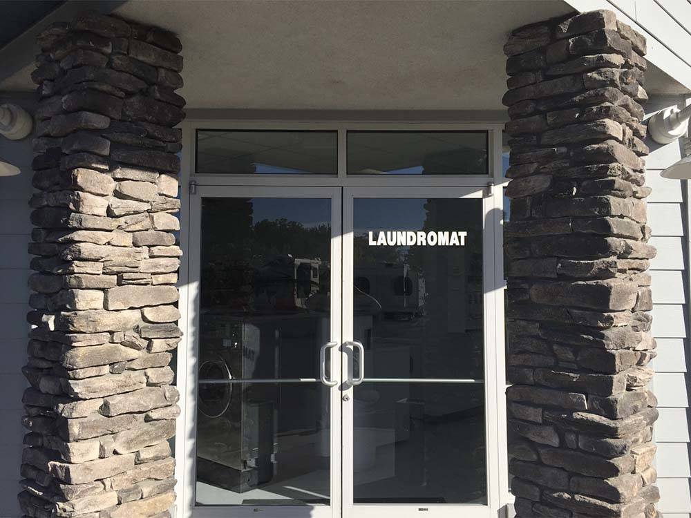 Laundromat entrance flanked by two stone columns at SPARKS MARINA RV PARK
