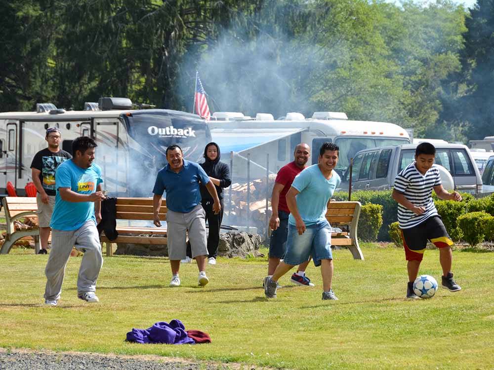 A group of men playing soccer at HOQUIAM RIVER RV PARK