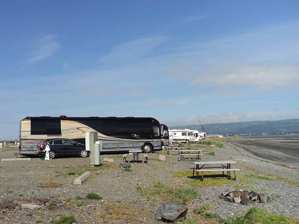A row of picnic tables at the gravel RV sites at HERITAGE RV PARK