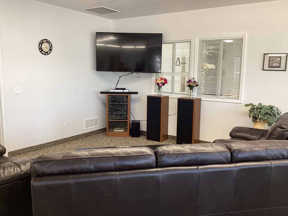 A TV and leather couch at AMBASSADOR RV RESORT