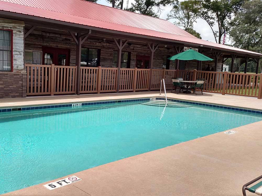 Swimming pool and deck area at WILD FRONTIER RV RESORT