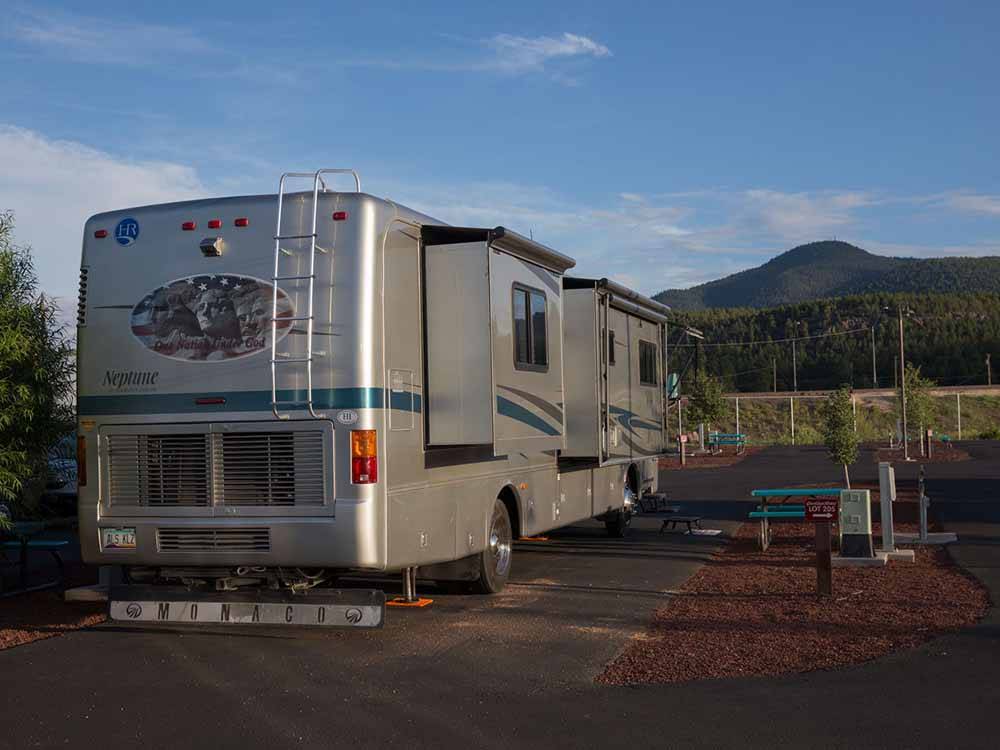 Class A motorhome parked in a gravel site at GRAND CANYON RAILWAY RV PARK