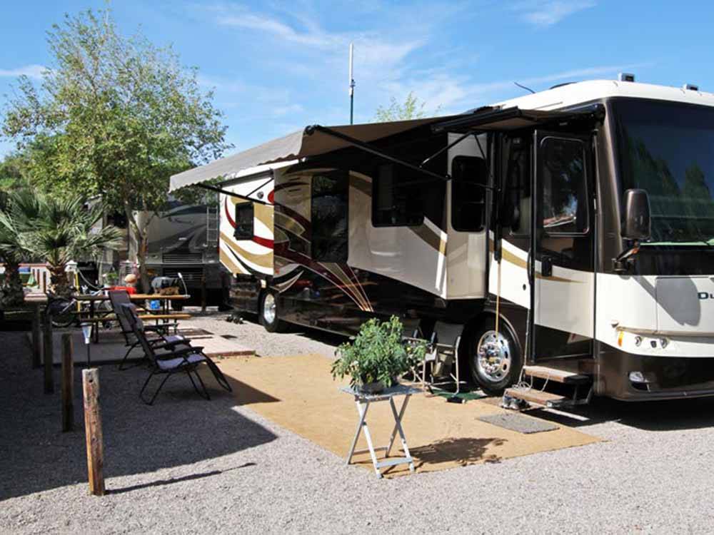 A motorhome in a gravel RV site at COLORADO RIVER OASIS RESORT