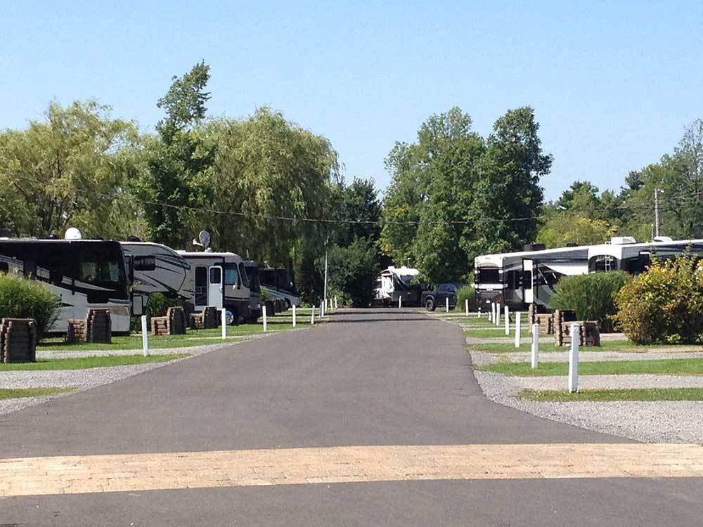 The swimming pool with orange and blue lounge chairs at CAMPING LA CLE DES CHAMPS RV RESORT